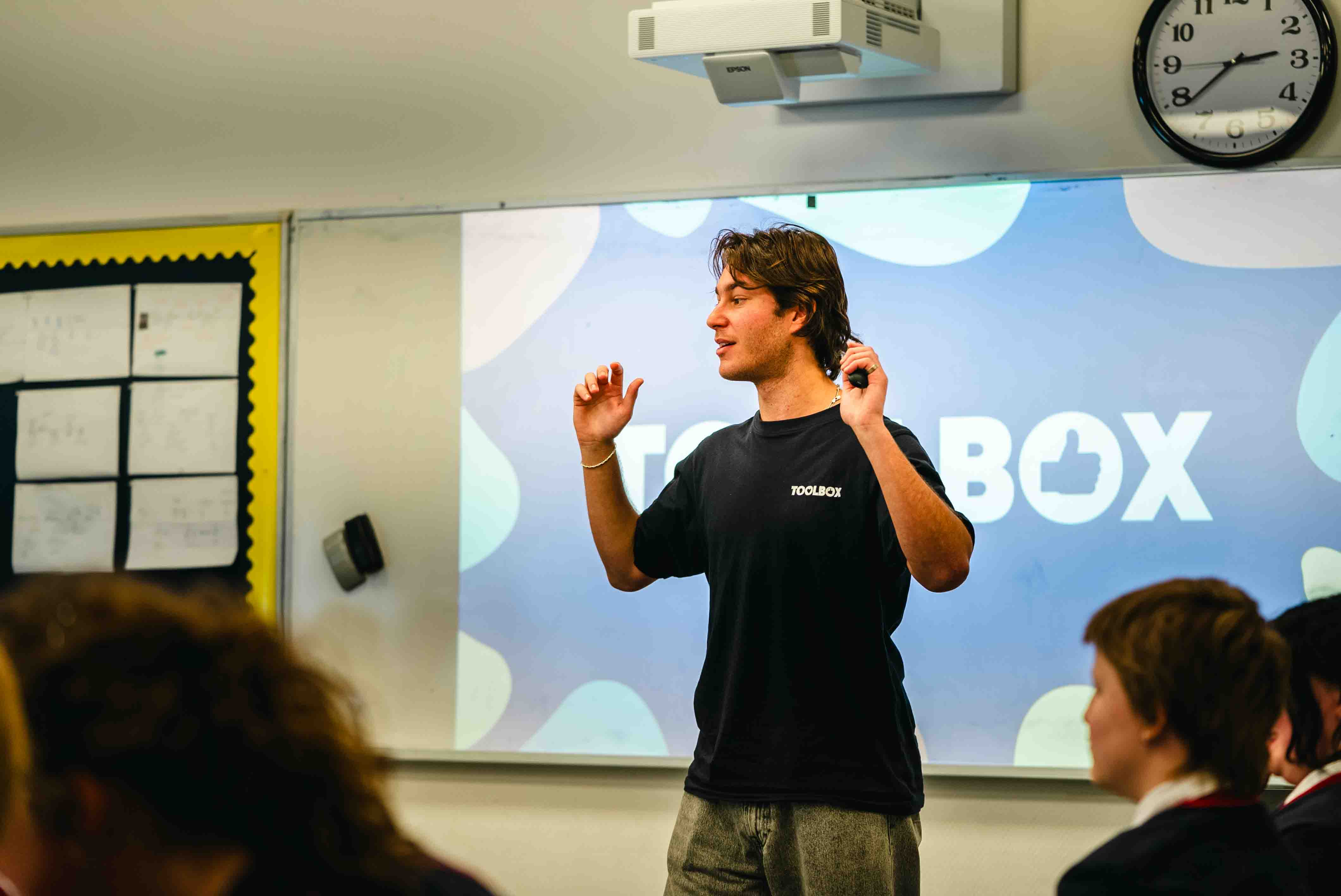 A Toolbox facilitator leading a discussion in front of a classroom