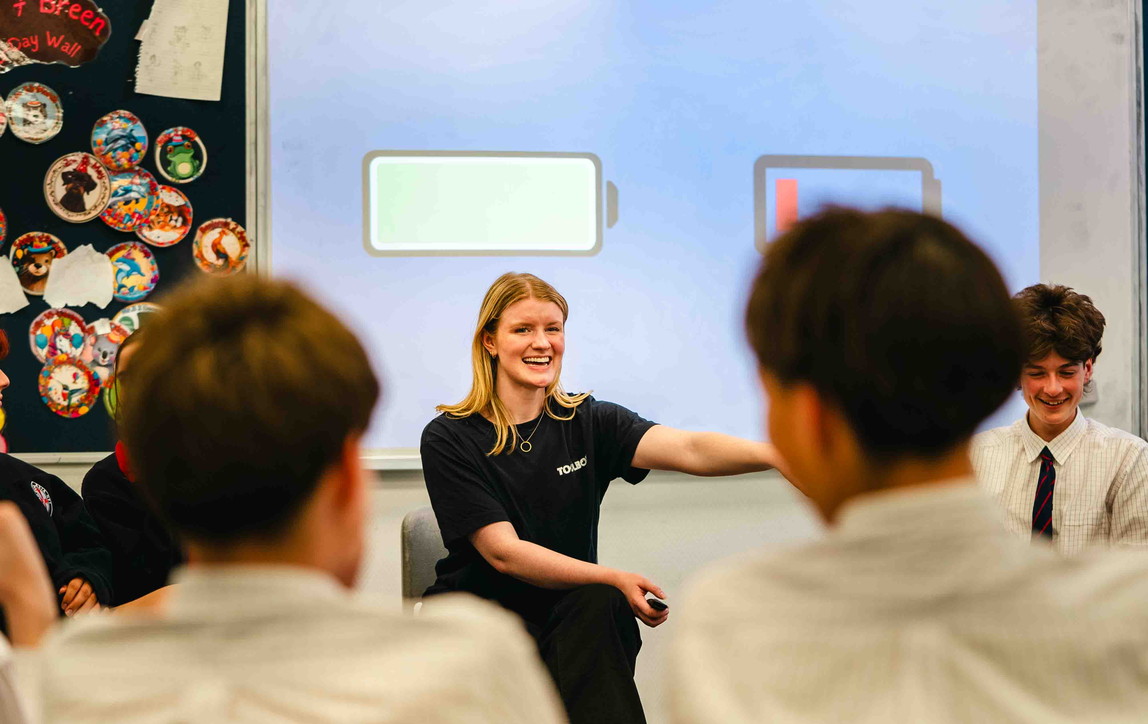 A Toolbox facilitator leading a discussion with a circle of secondary school students