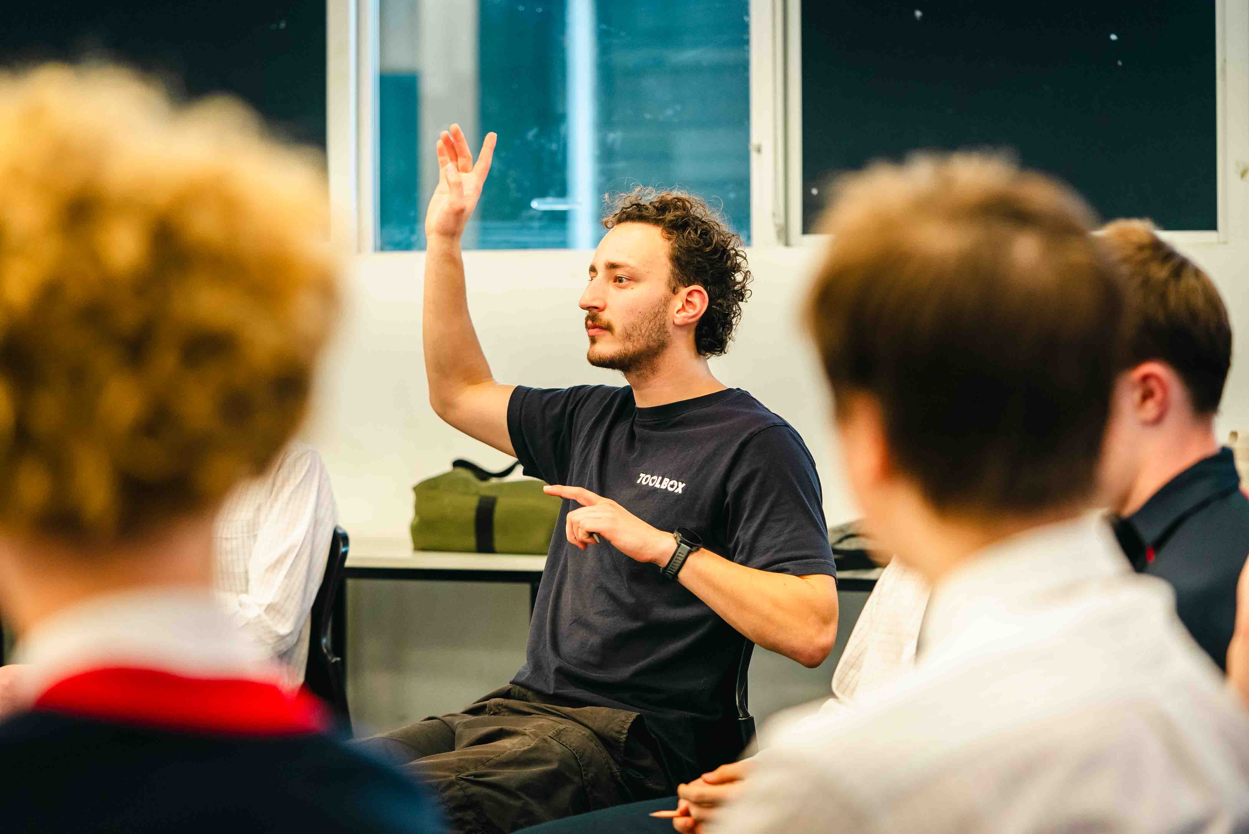 A Toolbox facilitator leading a discussion with a class of secondary school students